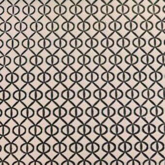Royal Botania rug, printed leather, dark brown and beige interlocking geometric pattern, consistent repeating circles and diamonds, studio shot.